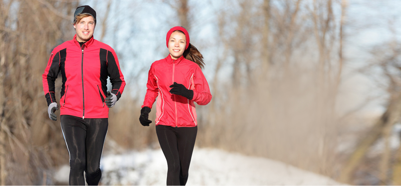male & female runner running in snow wearing BodyWarmer Thermal Hoop inside